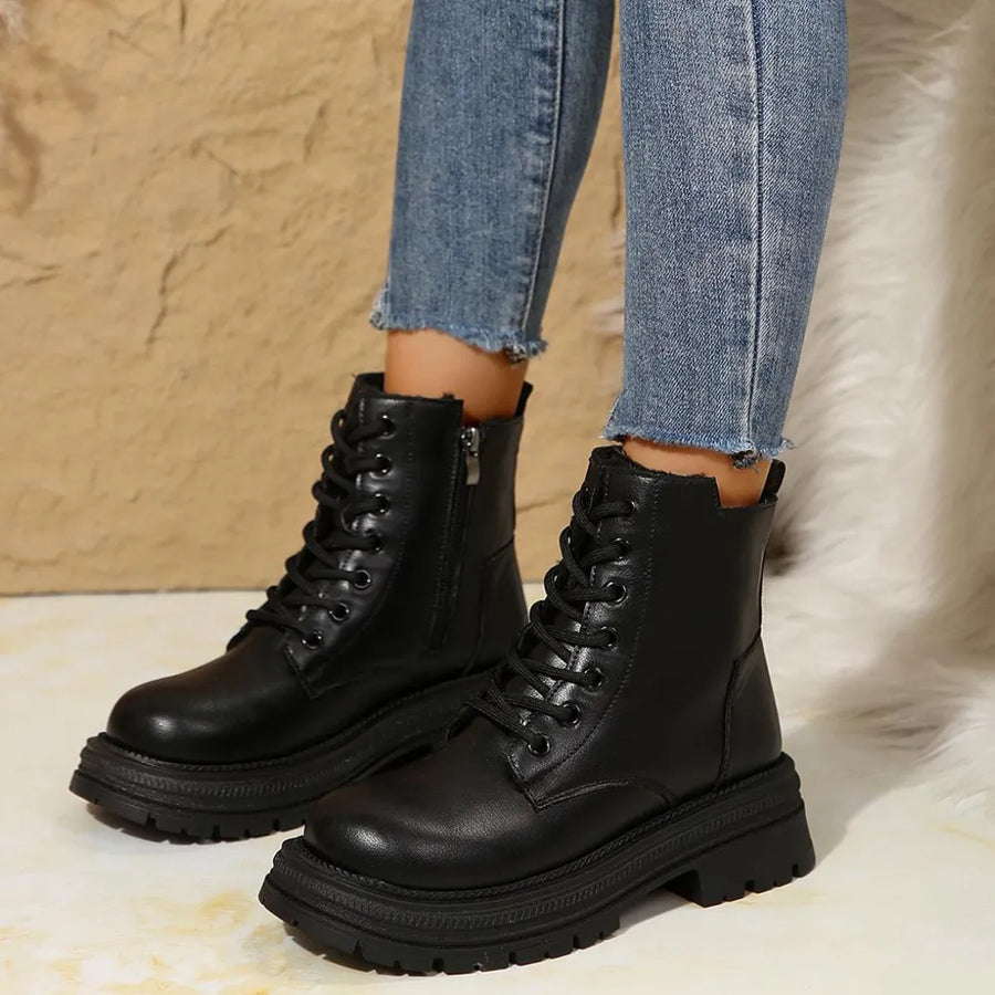 Black combat boots with side zip detail and lace-up front.