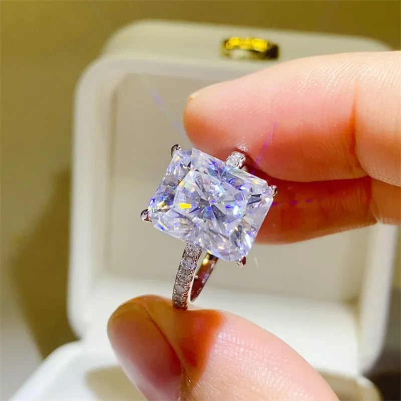 Radiant cut moissanite ring with pavé band in silver.