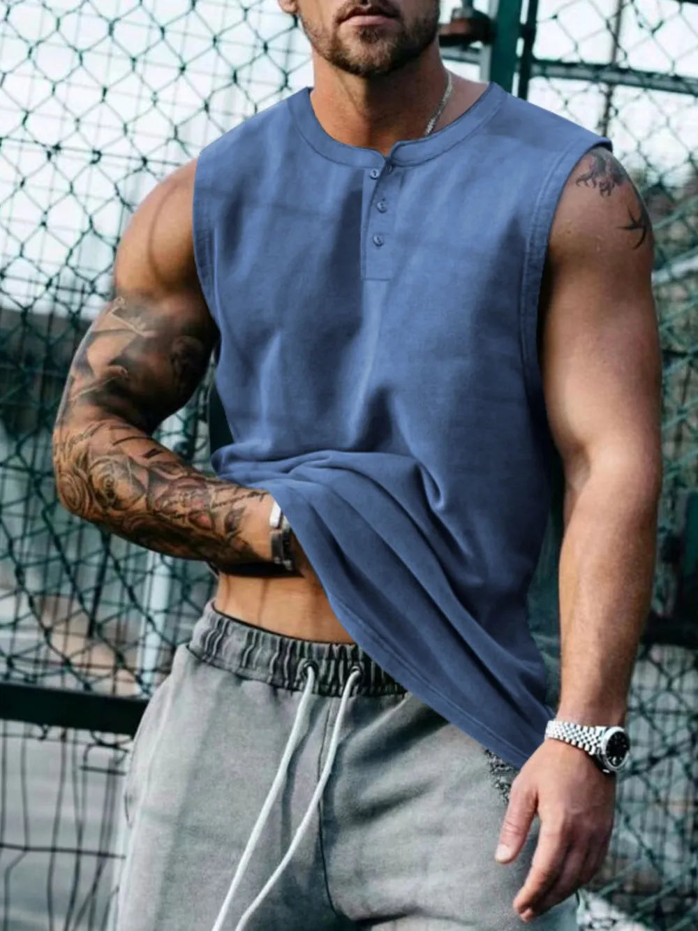 Sleeveless dusty blue henley muscle tank top with button detail.