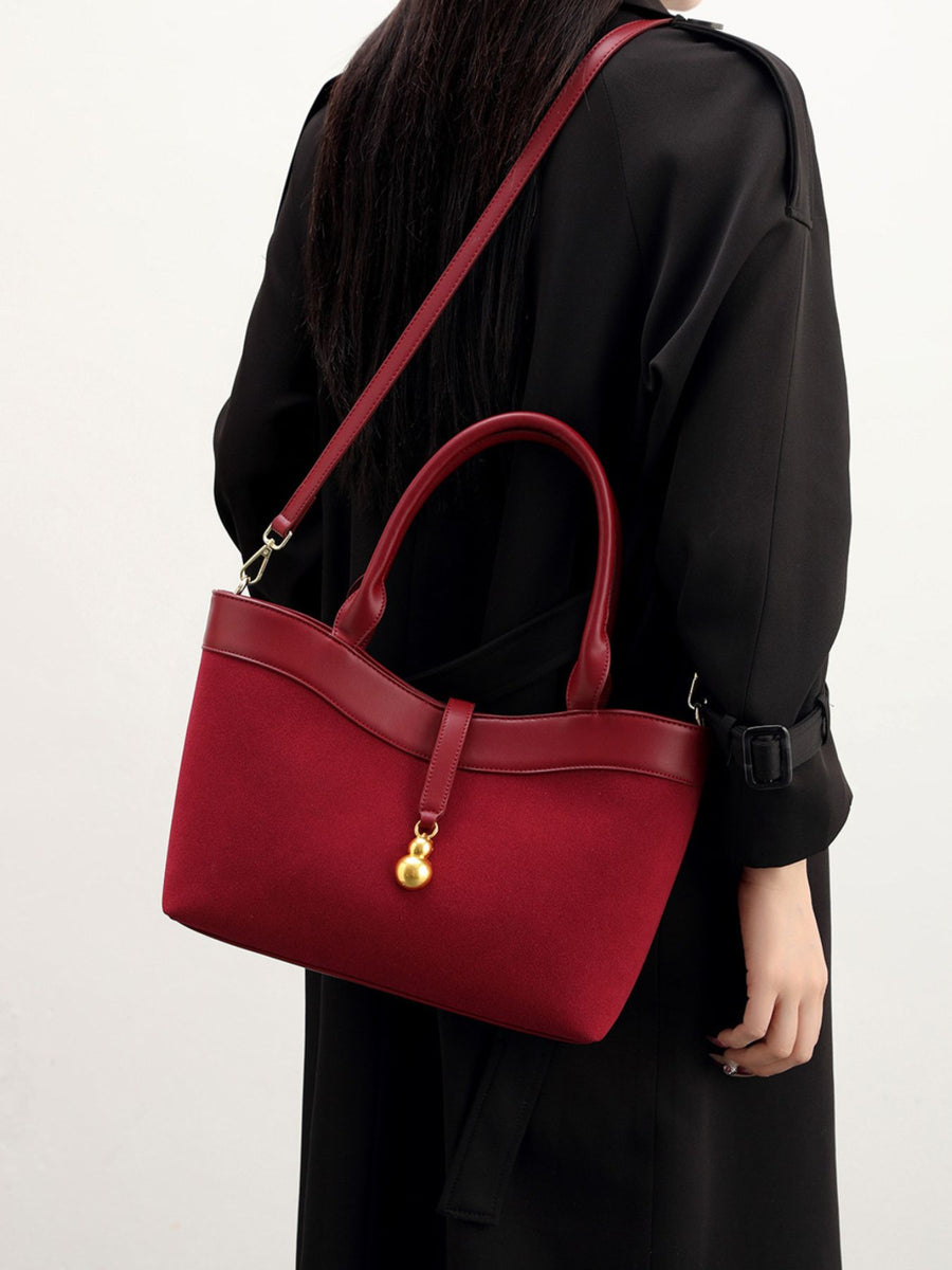 Suede Crossbody Bag With Gold Charm in burgundy
