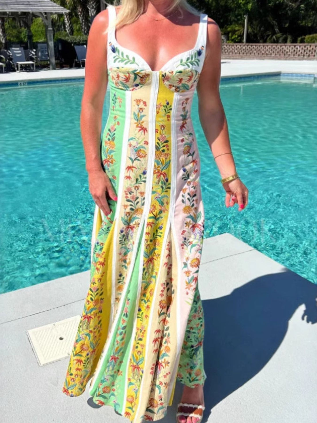 Sweetheart neck maxi dress with floral print panels in green, pink, and yellow.