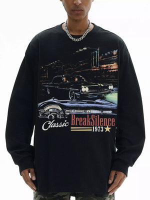 Black oversized long-sleeve top with classic car graphic and BreakSilence 1973 text.