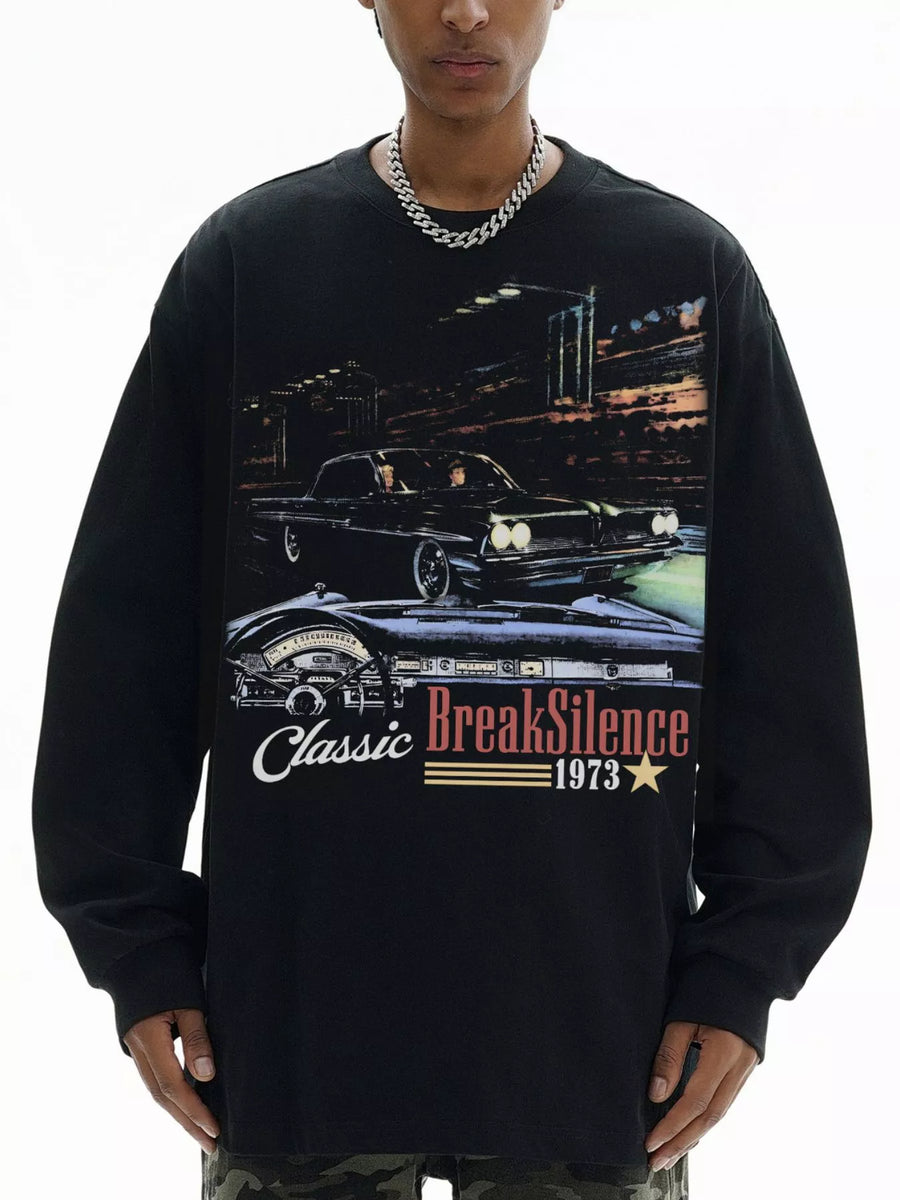 Black oversized long-sleeve top with classic car graphic and BreakSilence 1973 text.
