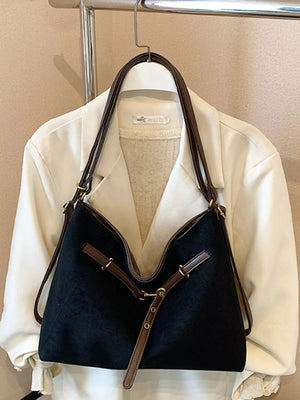 Black suede large tote bag with brown leather trim and gold hardware.