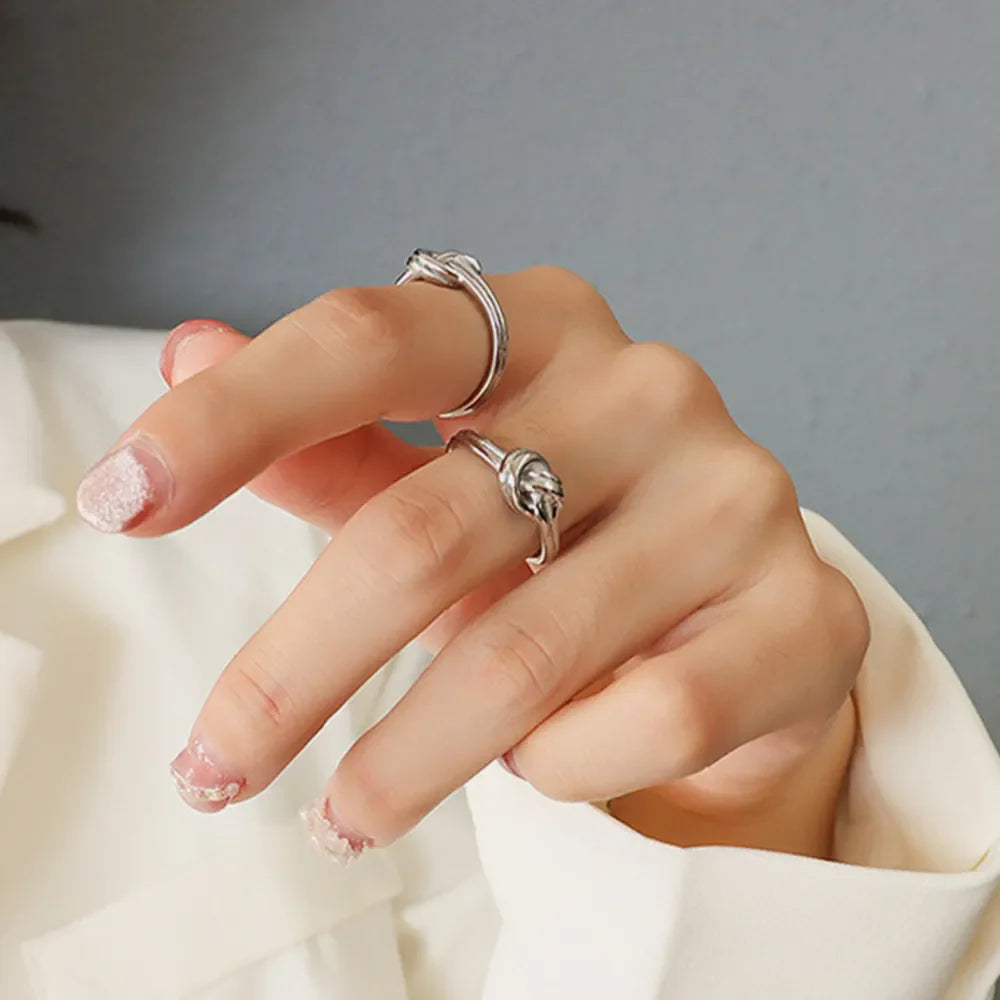 Sterling silver ring with knot detail on a hand