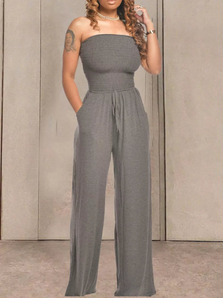Grey smocked strapless wide-leg jumpsuit with drawstring waist and pockets