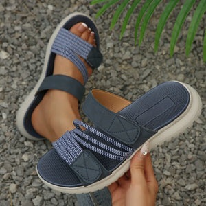 Blue multi-strap sandals with adjustable closure and textured footbed.