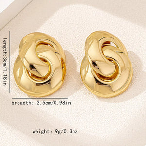 Chunky knot gold-plated earrings with oval base and interlocking chain detail.