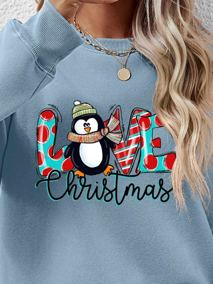 Festive penguin graphic sweatshirt in Misty Blue with "LOVE Christmas" text and polka dot and stripe details.