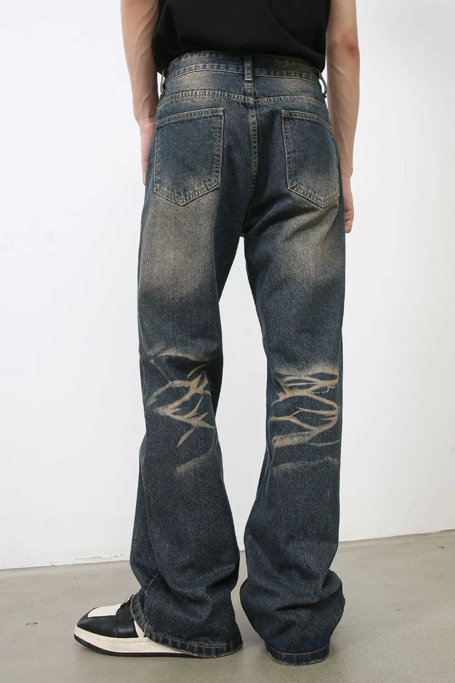 Faded wash wide-leg jeans in medium with distressed detailing and a relaxed fit.