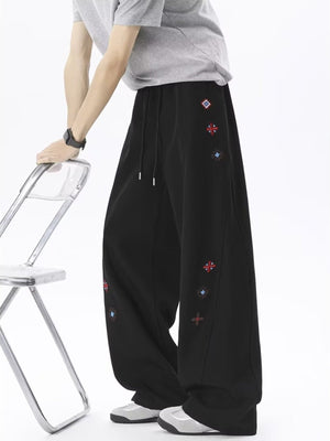 wide-leg pants in black featuring embroidered and loose fit