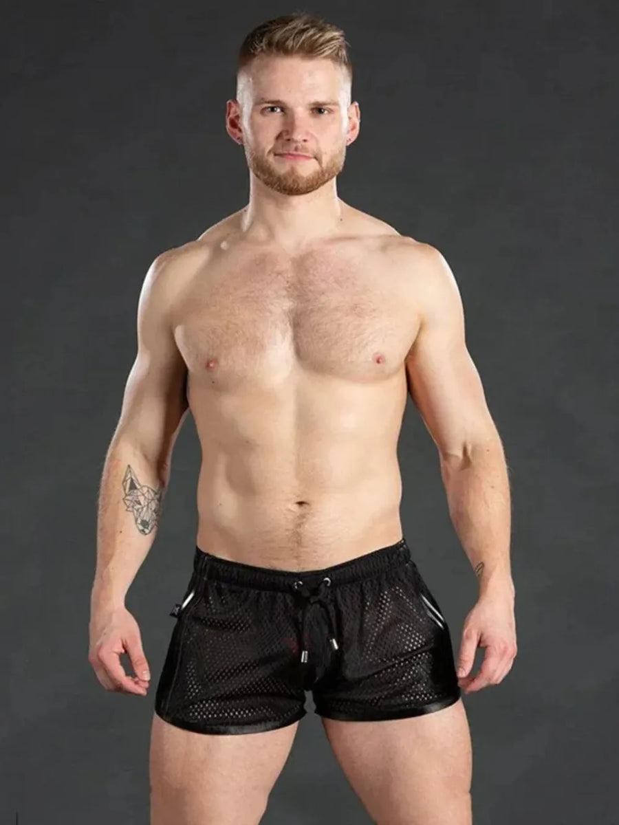 Black athletic mesh shorts with white trim and drawstring waist.