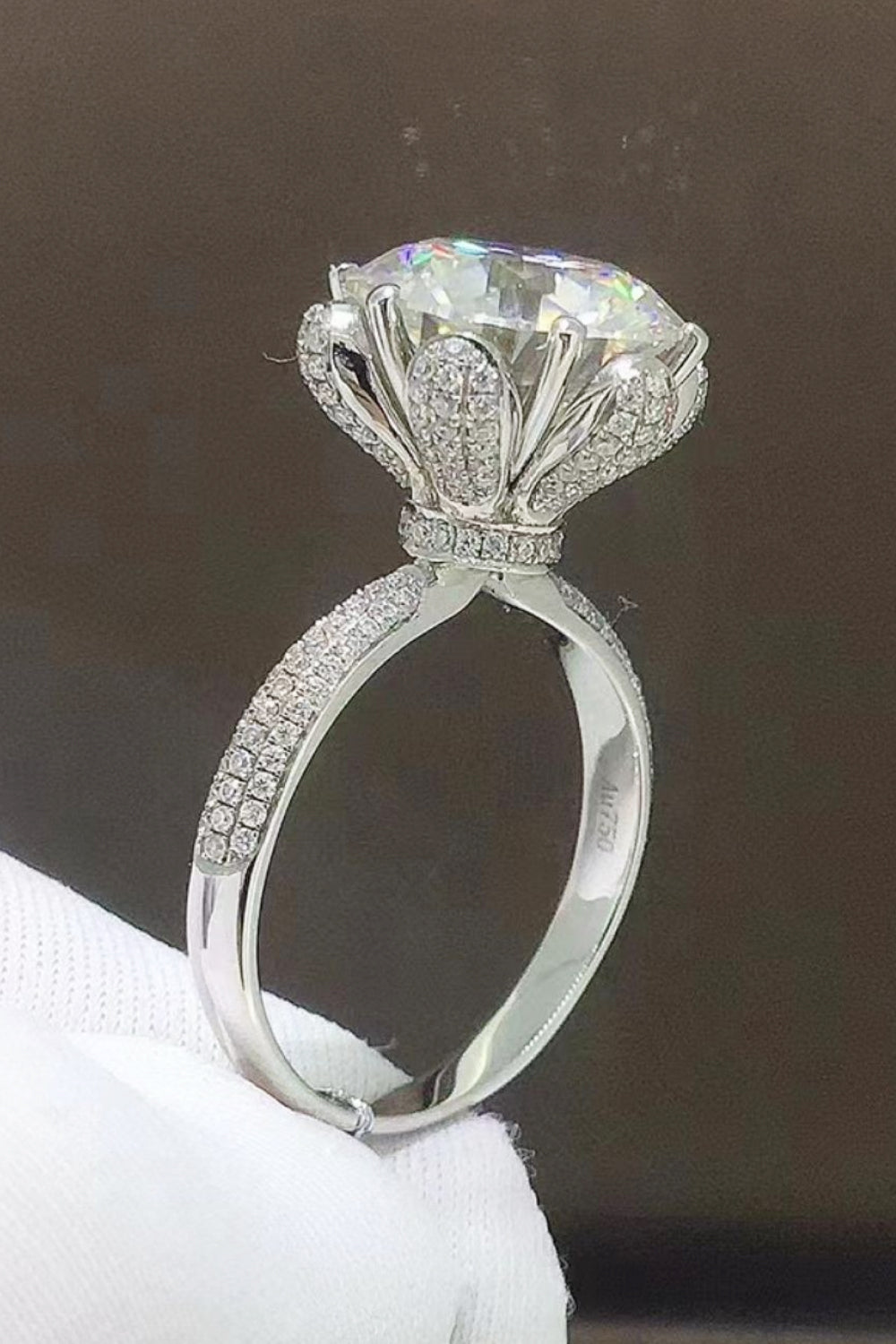 Sparkling Aura Moissanite Ring in silver with pavé band and detailed floral setting.