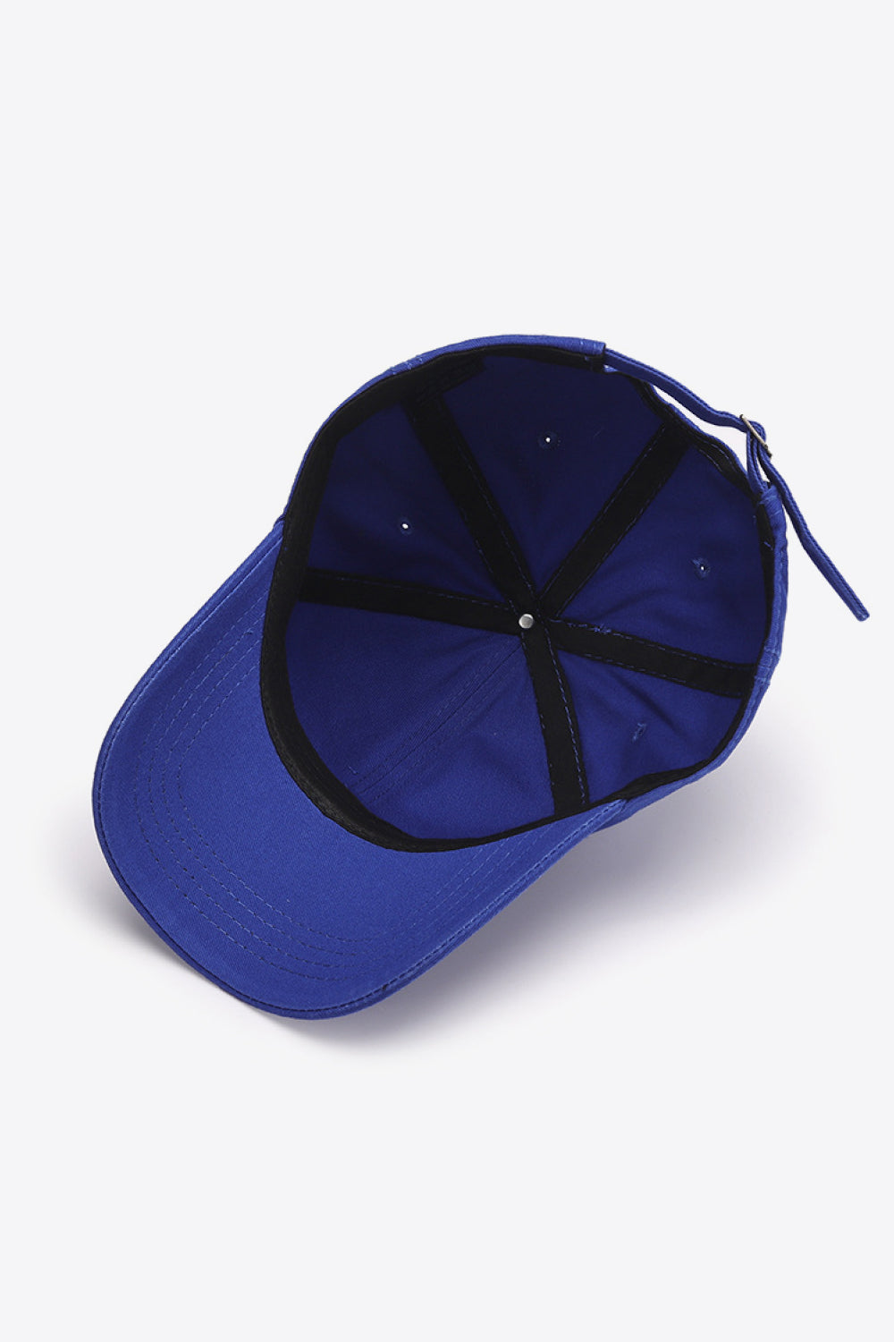Cobalt blue canvas baseball cap with adjustable strap and black interior lining.