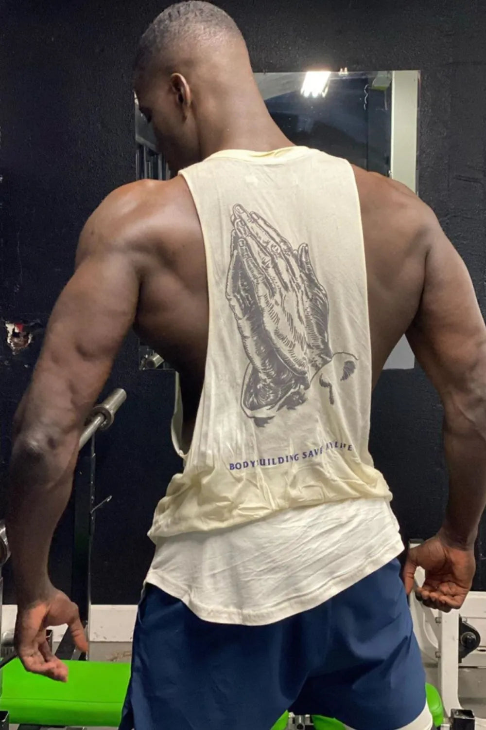 Beige graphic muscle tank top with praying hands and text graphic.