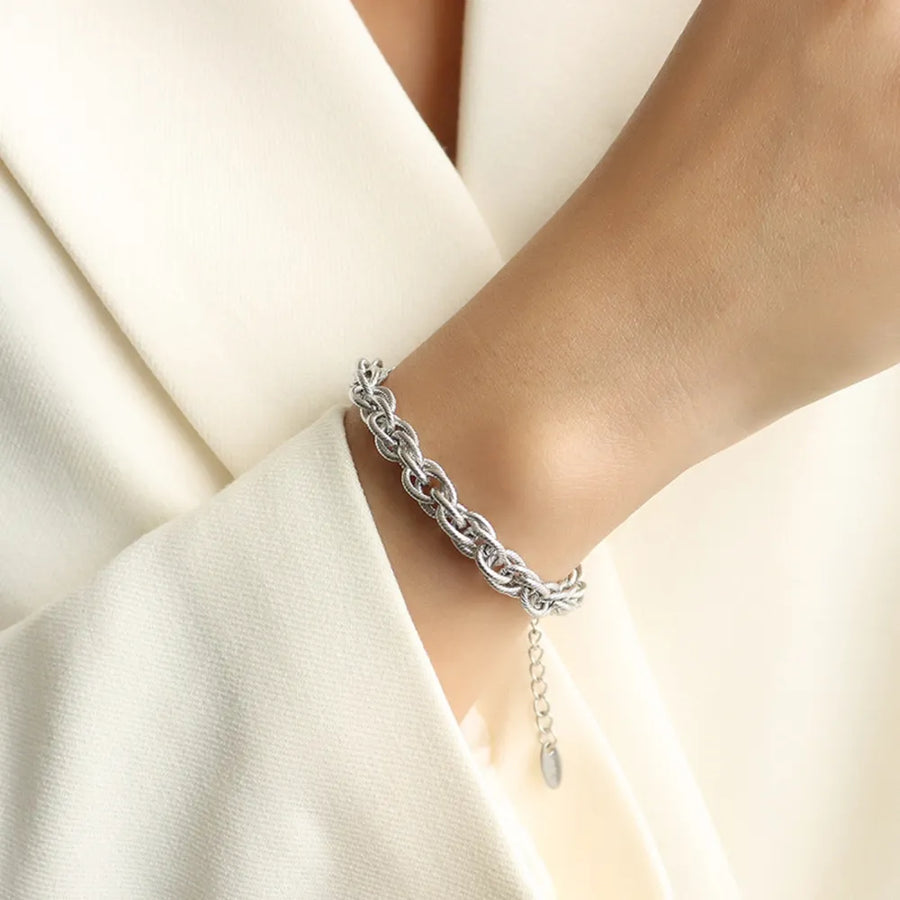 Silver textured rope chain bracelet with adjustable extender and oval charm.