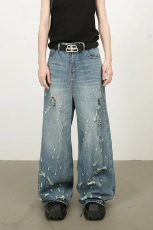 Distressed palazzo jeans in medium wash denim with raw edge detail and wide leg
