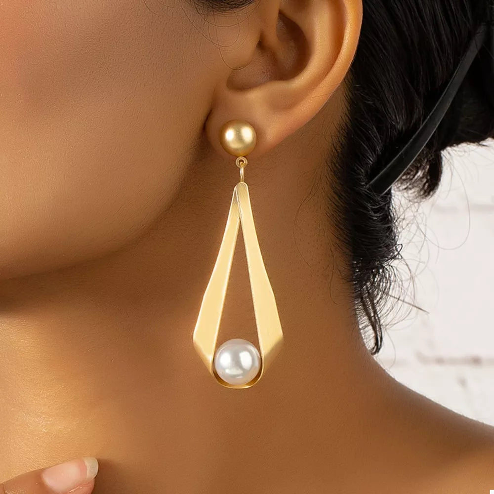 earrings in gold featuring drop design and geometric fit
