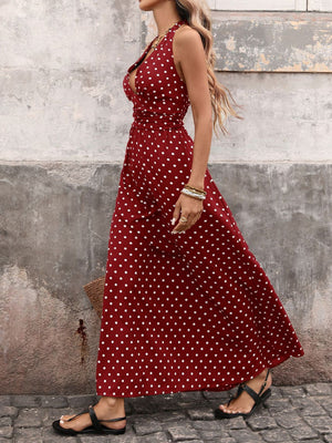 Burgundy polka dot maxi dress with halter neck and cinched waist.