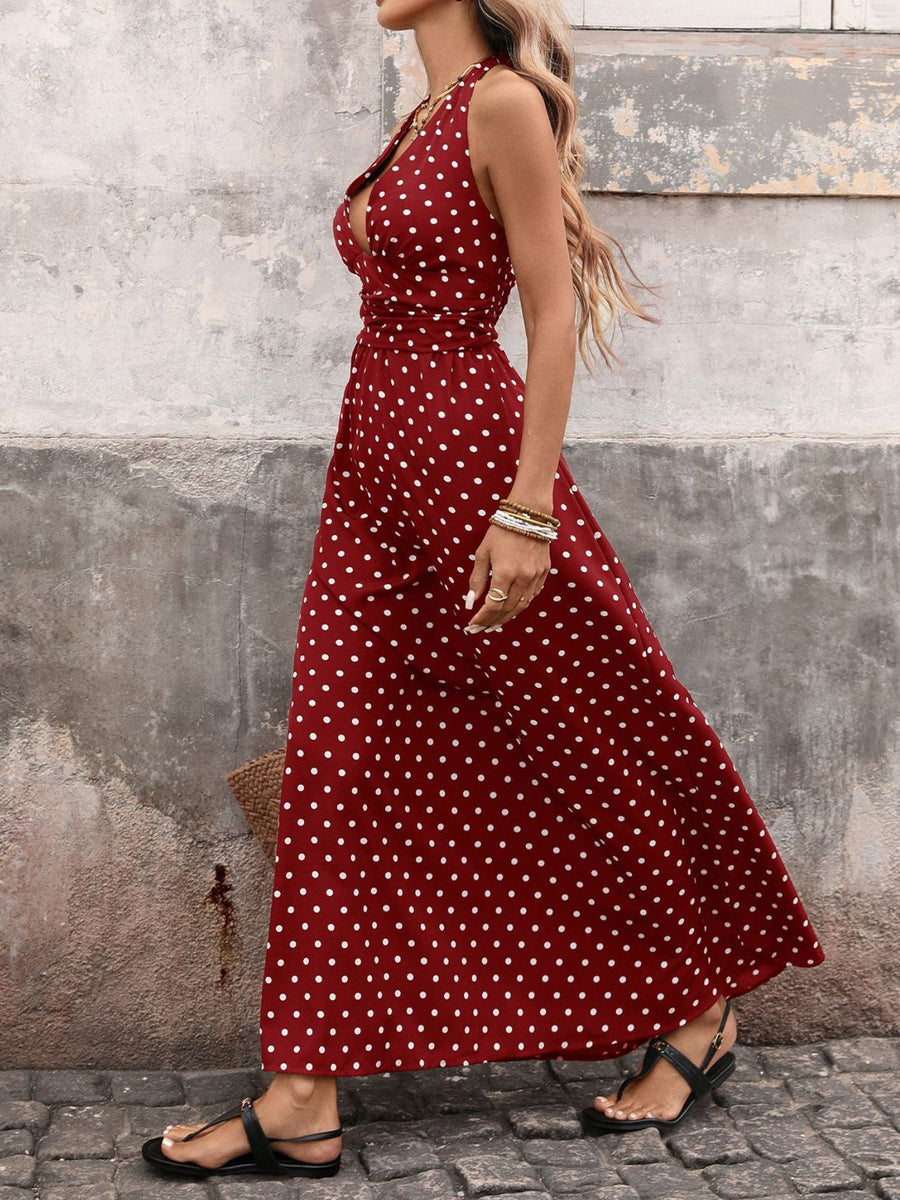 Burgundy polka dot maxi dress with halter neck and cinched waist.