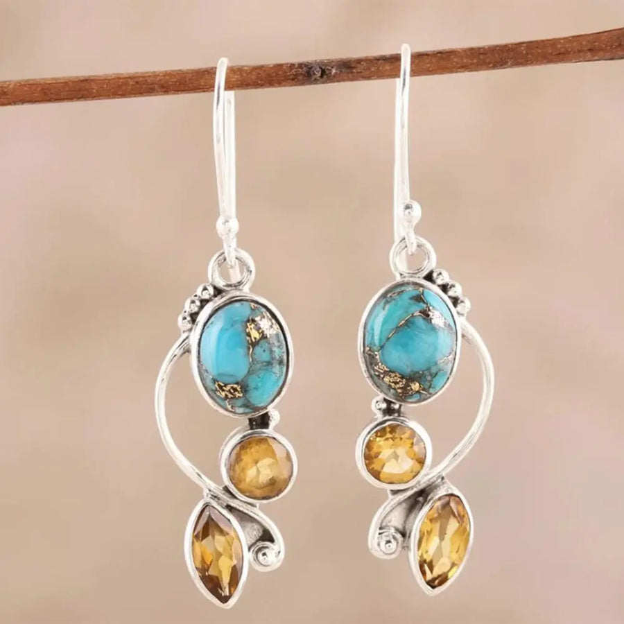 Silver dangle earrings with turquoise and citrine stones, artful sculptural design.
