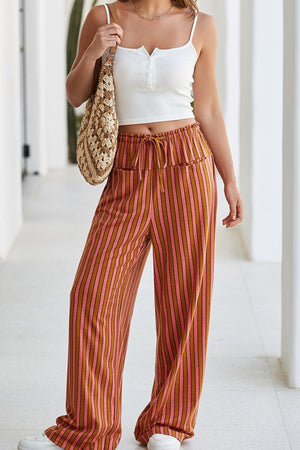 Wide leg pants with drawstring waist and vertical pink and brown stripes.