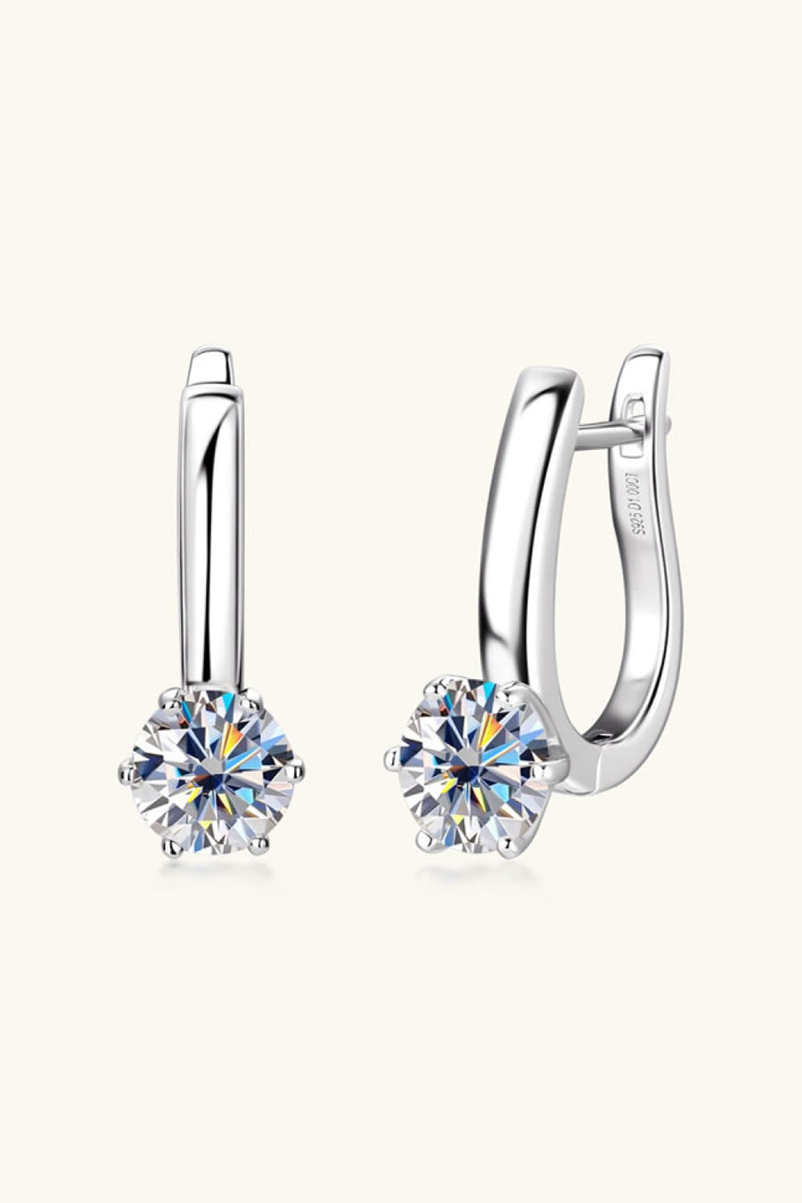 Silver solitaire huggie hoop earrings with sparkling cubic zirconia stones.