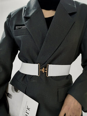 White elastic belt with gold sculpted buckle detail
