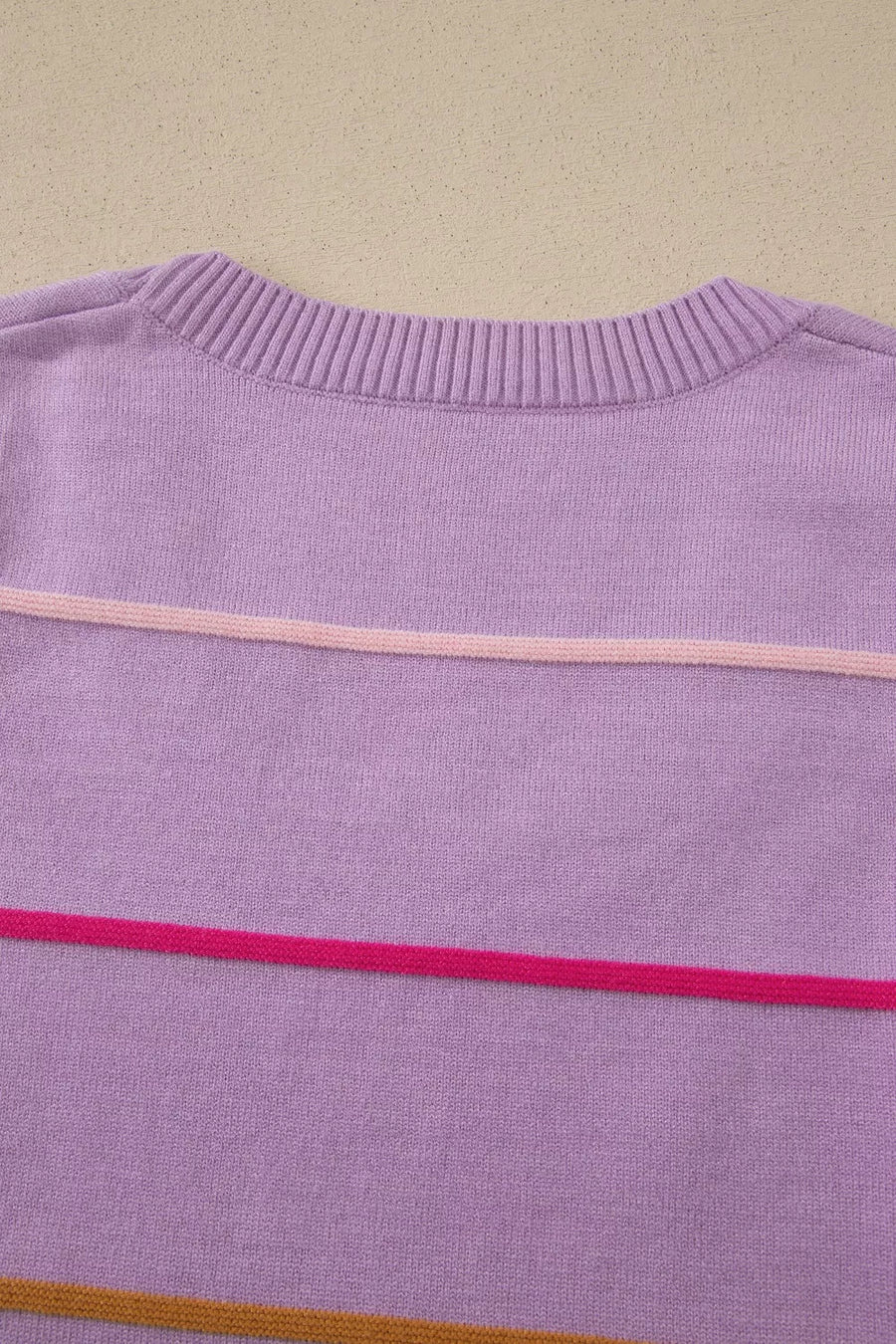 Lavender knit sweater vest with horizontal pink and orange stripes.