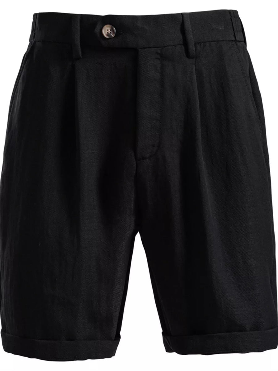 Black pleated chino shorts with button closure and cuffed hems.