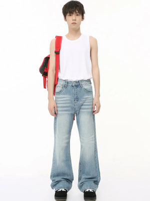 Wide leg washed denim trousers in medium blue with a relaxed fit.