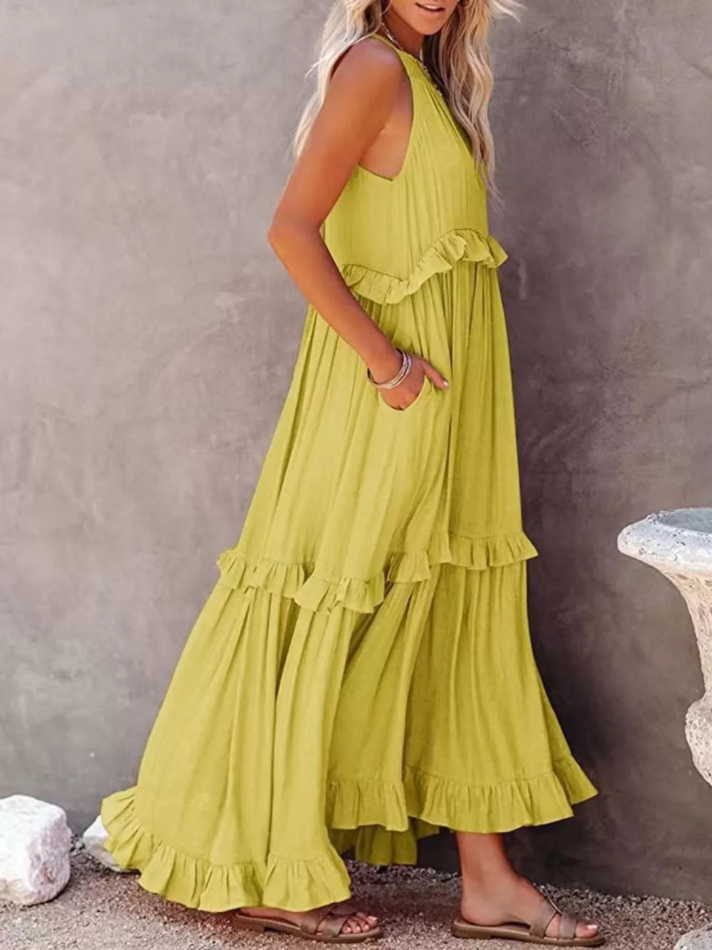 Yellow ruffled maxi dress with pockets and tiered skirt.
