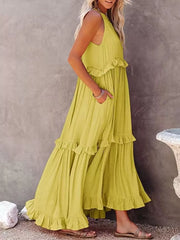 Yellow ruffled maxi dress with pockets and tiered skirt.