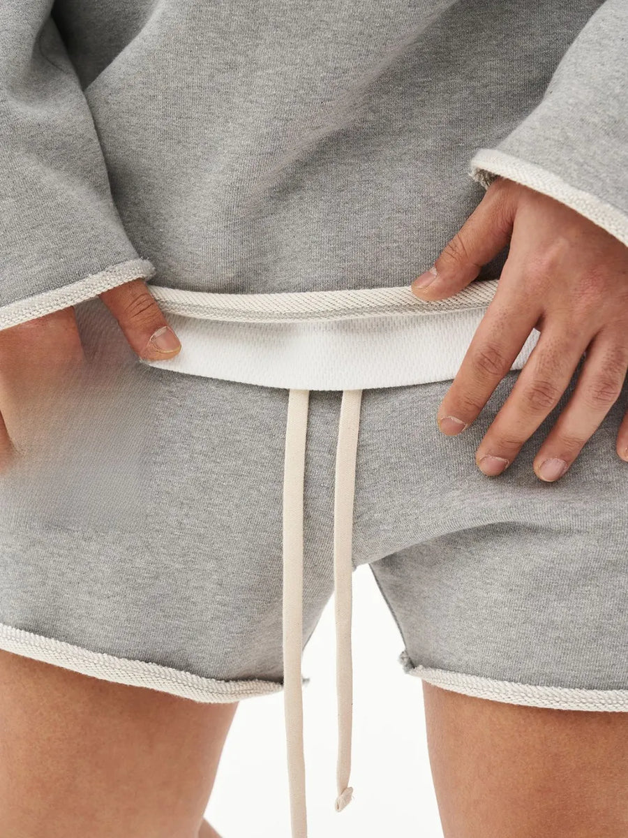 Gray fleece lounge shorts with raw edge hem and drawstring.