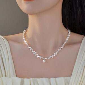 Lustrous irregular pearl pendant necklace with delicate chain and single pearl drop.