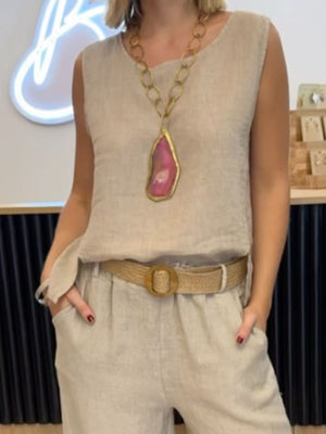 Relaxed fit tank and wide-leg pants set in light beige with a woven belt and statement necklace.