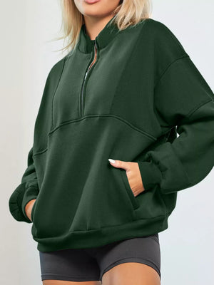 Dark green half zip stand collar sweatshirt with front pocket and ribbed panel details.