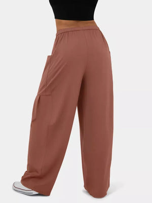 Rose red maternity pants with wide legs and cargo pockets, styled casually.