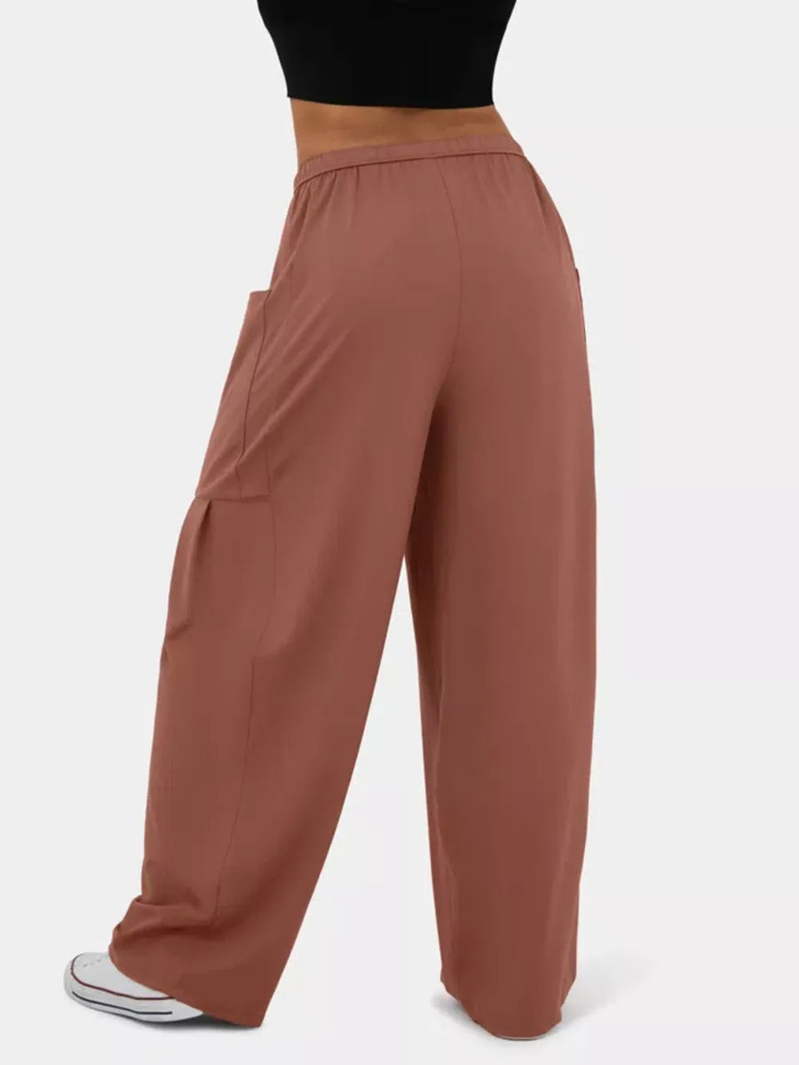 Rose red maternity pants with wide legs and cargo pockets, styled casually.