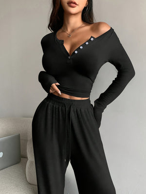 Black two-piece set with cropped top, full-length pants and half-button, drawstring, elastic