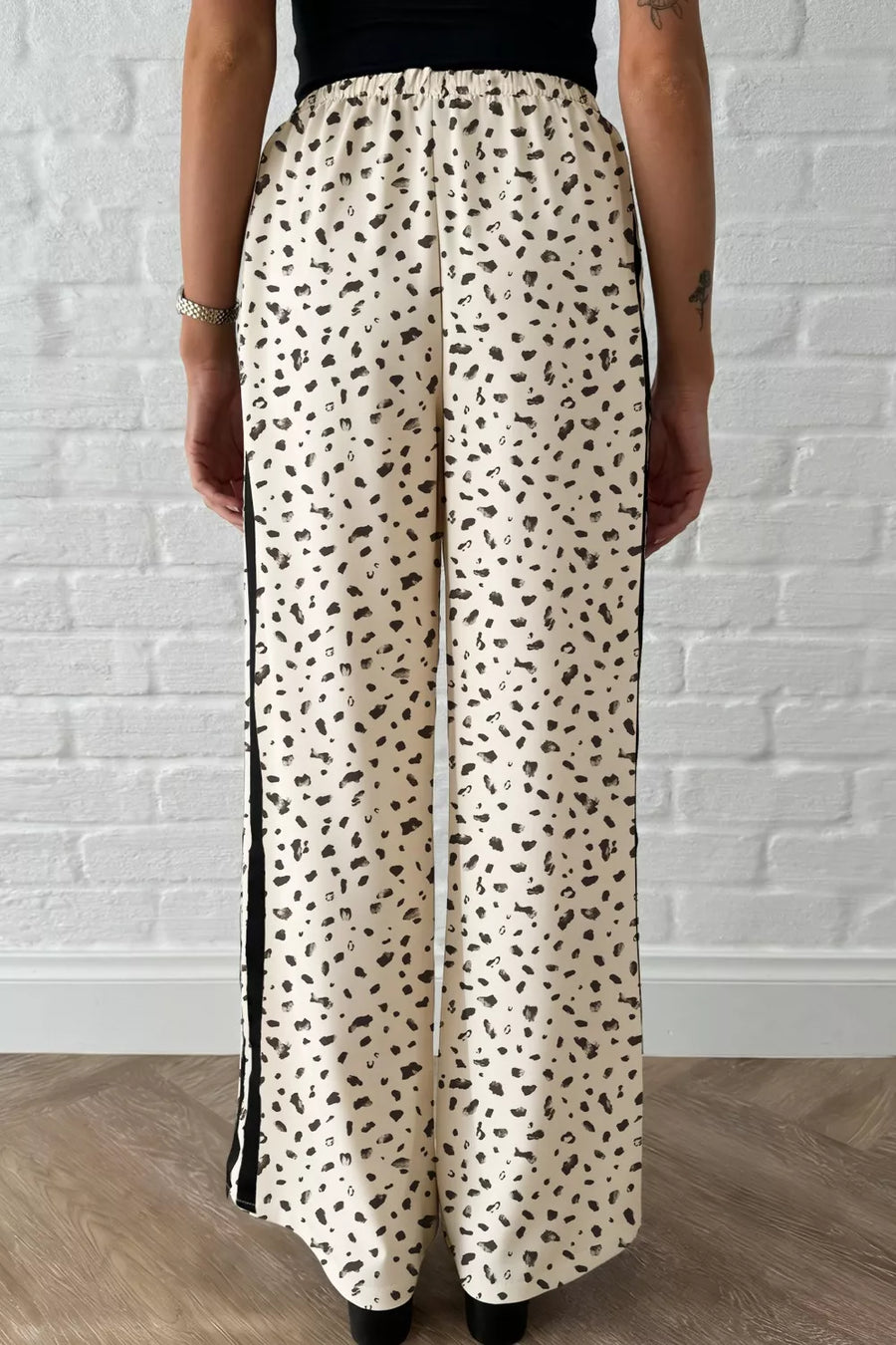 Maternity leggings with cream leopard print and black side stripes.