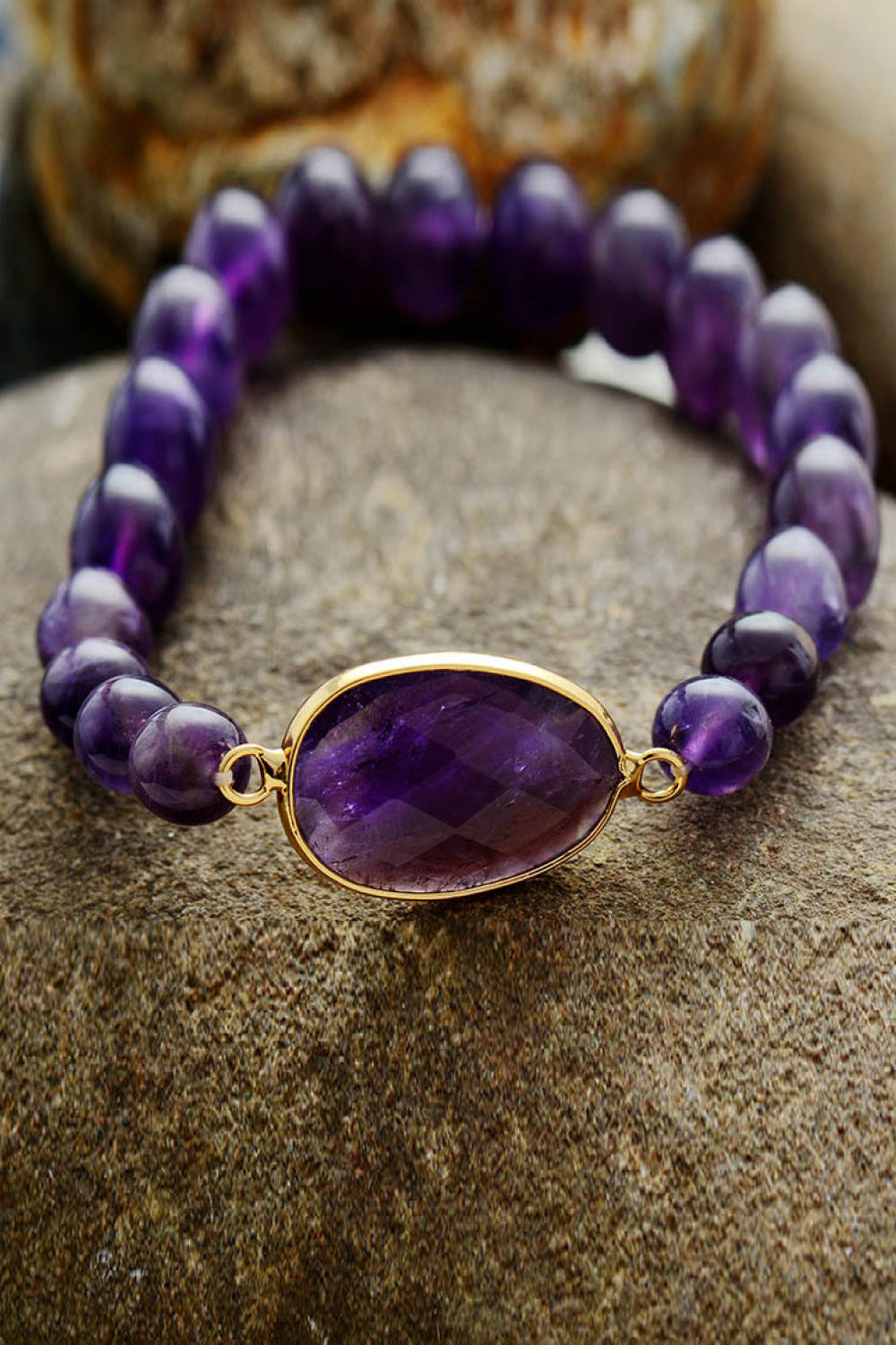 Violet amethyst beaded bracelet with faceted oval stone and gold bezel.