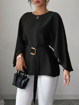 Black belted blouse with batwing sleeves and gold buckle detail.