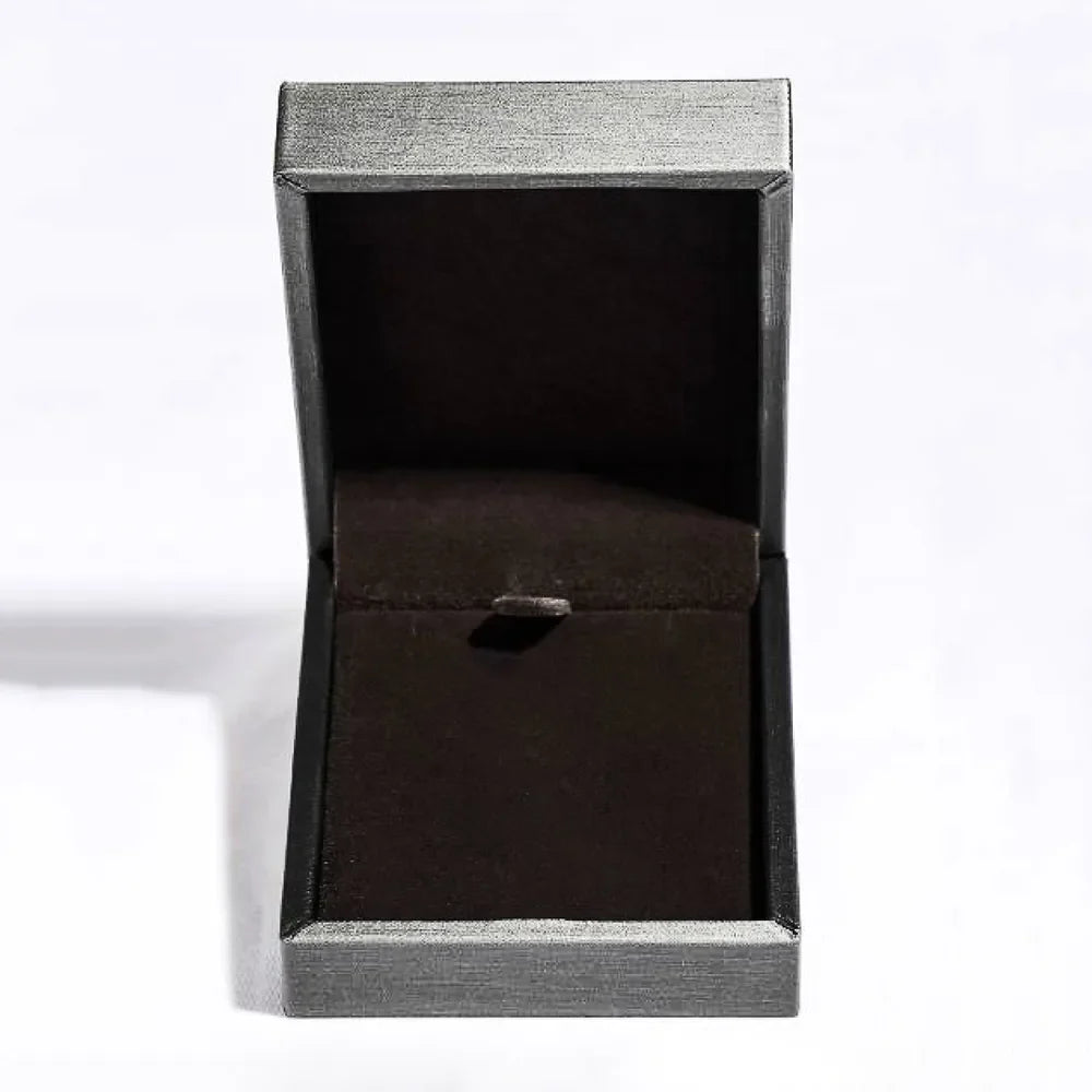 Open jewelry box with dark velvet lining and silver textured exterior.