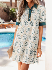 Floral print polo collar mini dress in cotton with buttoned placket and green trim.