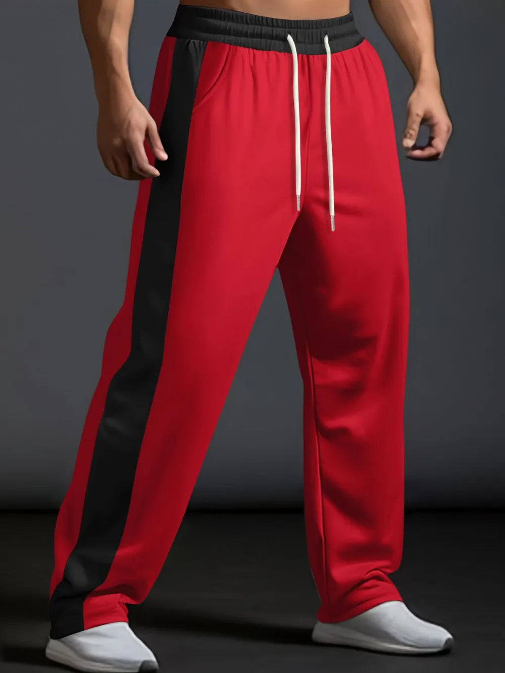 Red track pants with black side panel detail and white drawstring.