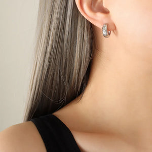 Silver zirconia-embellished mini huggie hoop earrings with subtle detailing.