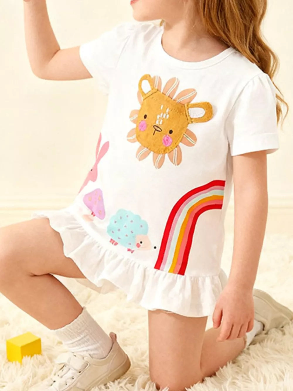 White cotton tee with playful animal graphics and a ruffle hem.