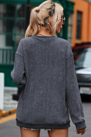 Dark gray ribbed sweatshirt with crew neck and long sleeves.