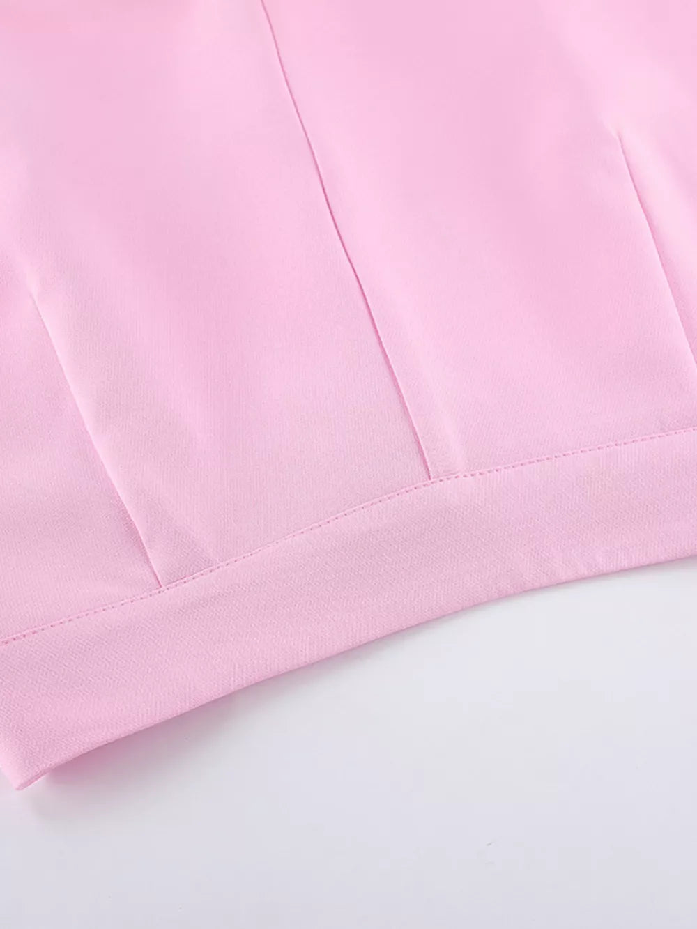 light pink two-piece set with hip-length top, full-length bottom and button, zipper